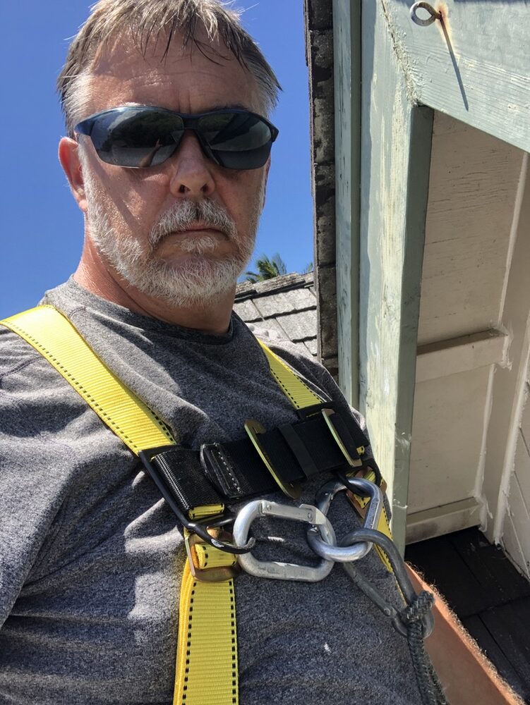 Joe Quentin Sr. — Certified Master Inspector, on a Kauai roof with safety harness
