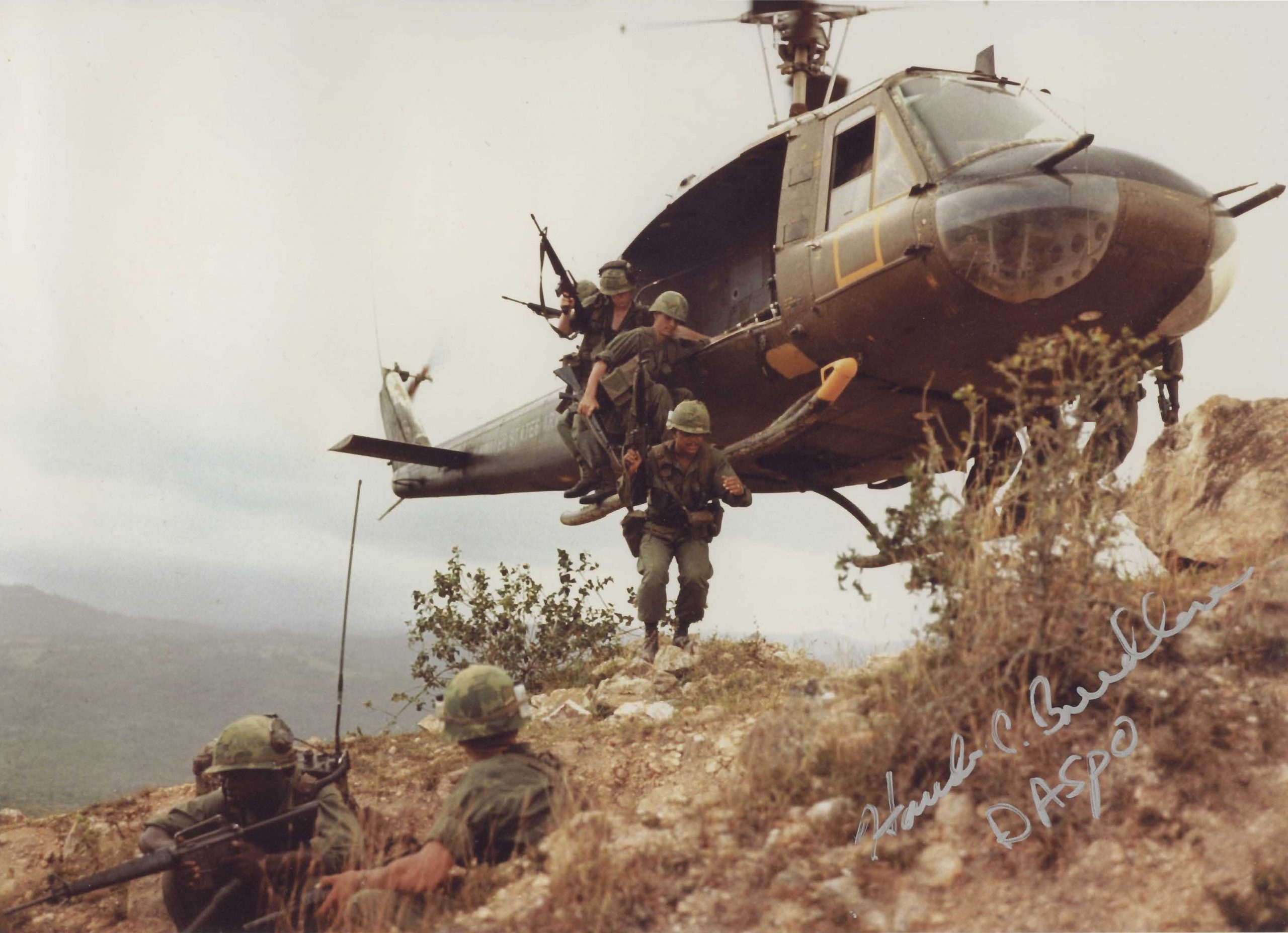 Soldiers disembarking from a UH-1 helicopter onto a ridge near Duc Pho, Vietnam, in April 1967.